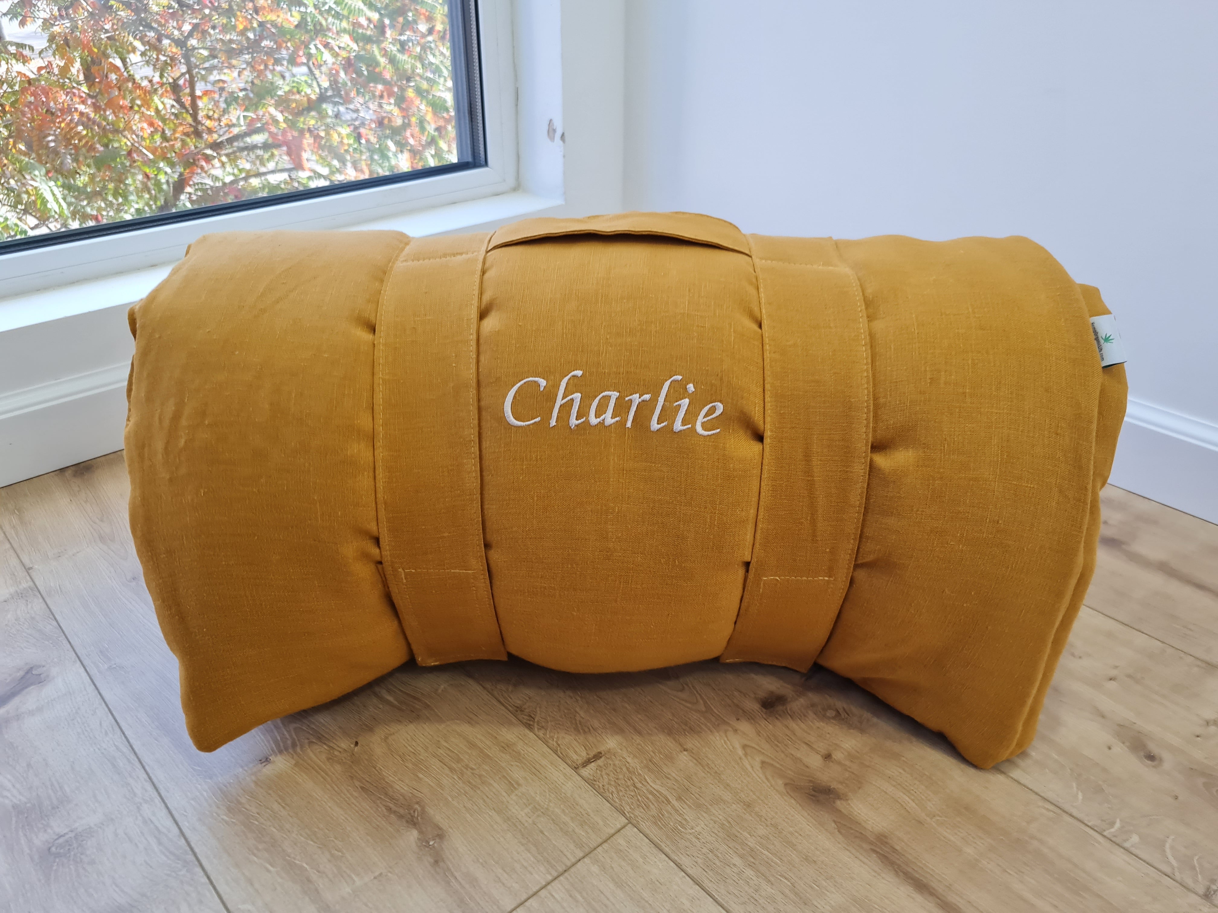 Special listing for Casey Heitmann one 38"L x 26" W hemp sleeping bag with pillow in mustard linen fabric, with white thread embroidery of the Rowen name, with a grey mat inside 2.3" thick